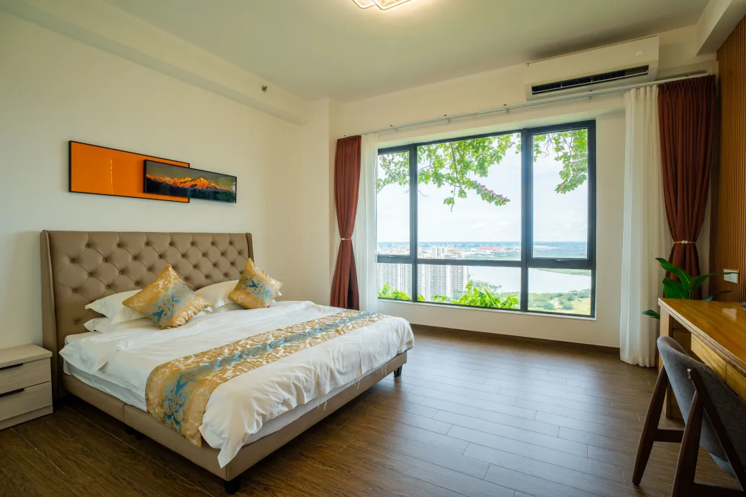 A comfortable hotel guest room with a wide city view