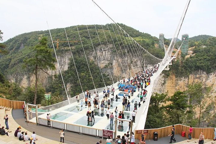 Visitors crossing a mountain bridge in Zhangjiajie