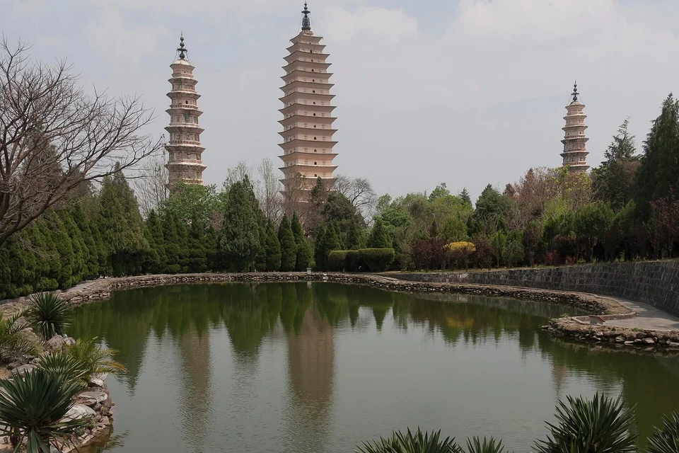 The Three Pagodas beside a reflecting pond in Dali